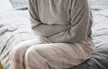 Irritable Bowel Syndrome (IBS), image of a woman holding her stomach.