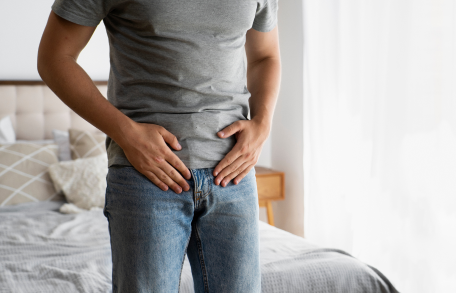 Irritable Bowel Syndrome (IBS), image of a man holding his stomach.