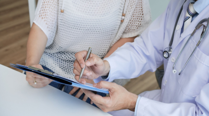 Polycystic Ovary Syndrome (PCOS), image of a doctor and patient reviewing information shown on a clipboard.