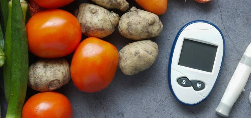 Metabolic Medicine, an image of tomatoes, potatoes, carrots and okra on a grey counter with a medical device